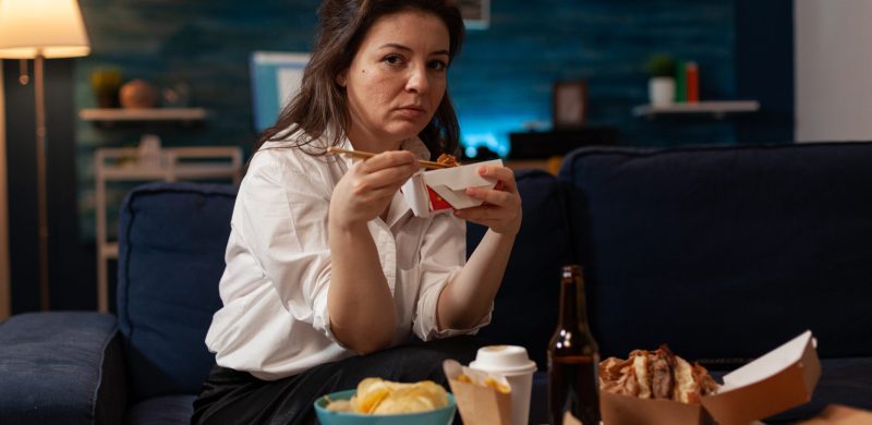 portrait-smiling-woman-eating-takeout-asian-noodles-with-chopsticks-living-room-sofa-office-worker-sitting-couch-evening-enjoying-chinese-takeaway-ramen-box-delicious-junk-food.jpg