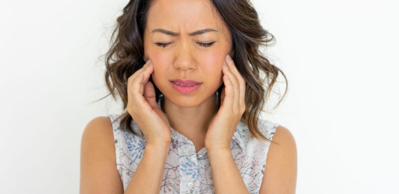 worried-young-woman-frowning-touching-cheeks.jpg
